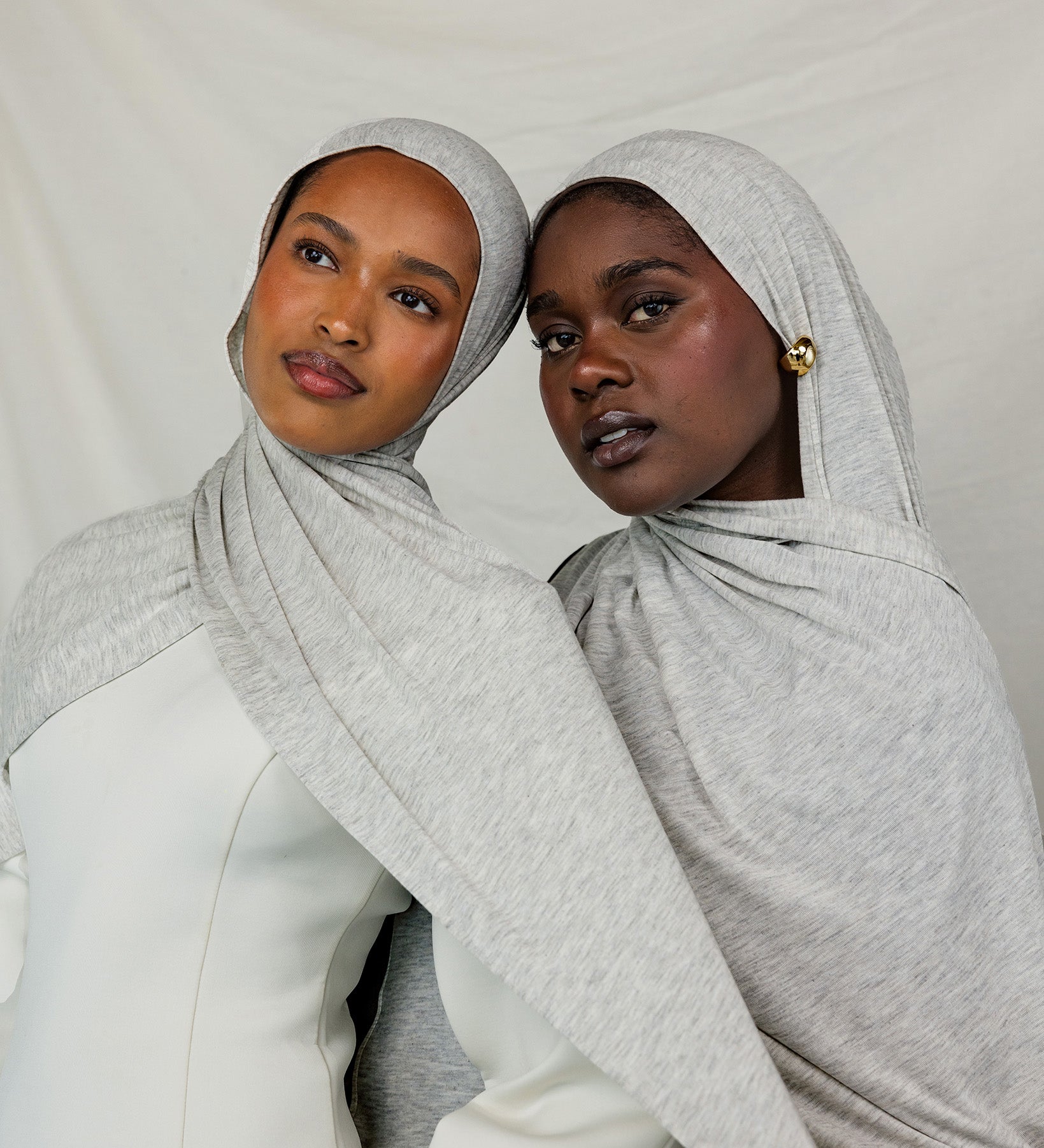 Two models wearing Marble Grey Jersey Lite, highlighting how the heathered grey hue complements different skin tones.