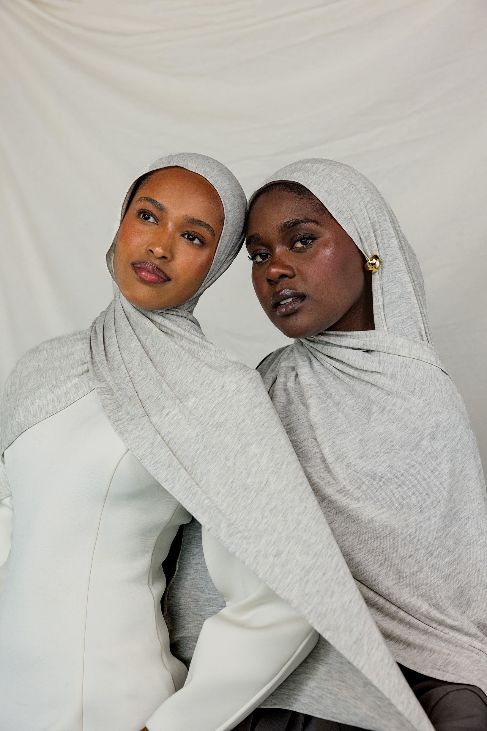 Two models wearing Marble Grey Jersey Lite, highlighting how the heathered grey hue complements different skin tones.