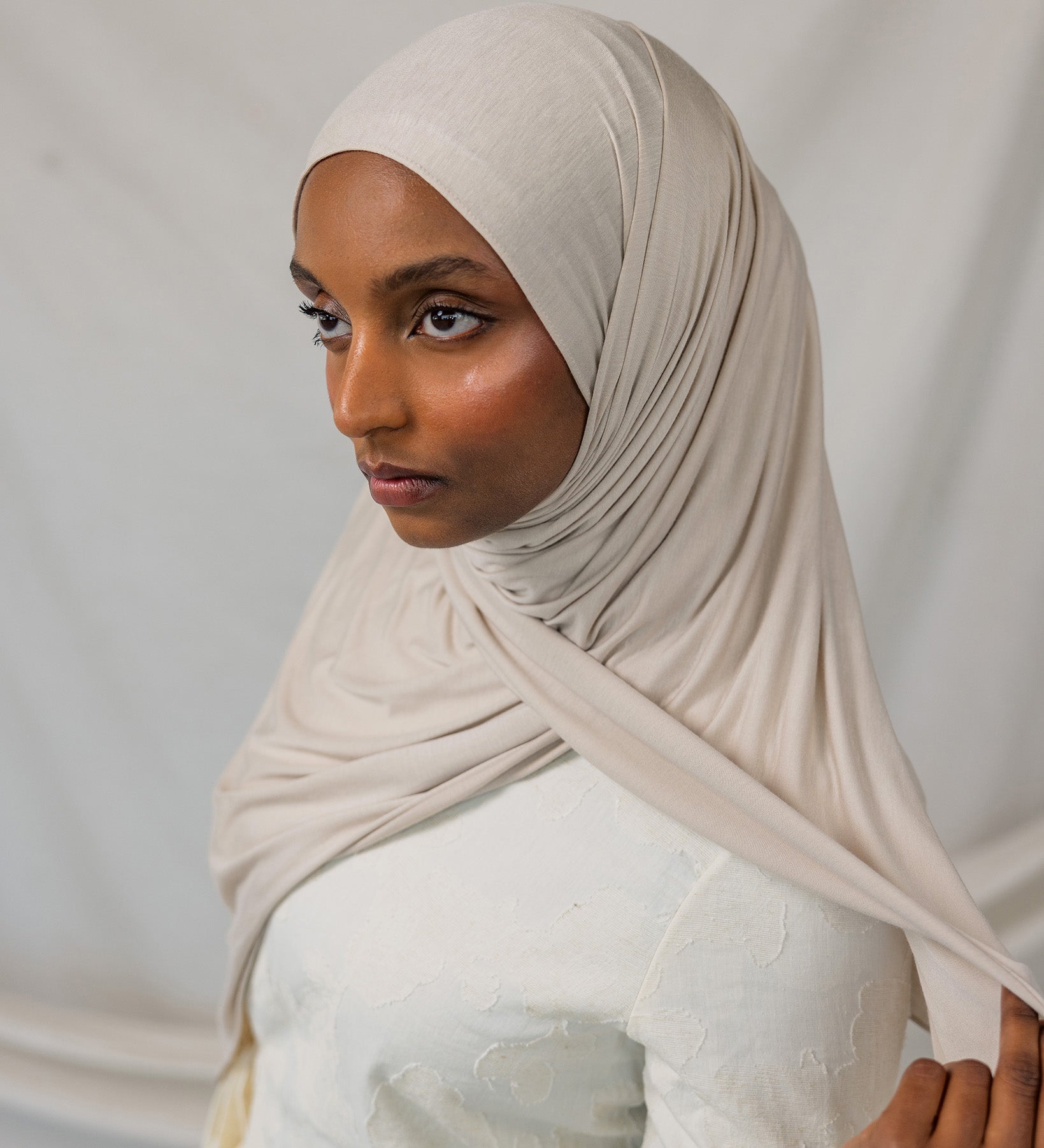Model wearing Ashwood Jersey Lite in a loose front wrap, showing its versatile neutral hue and stretch.