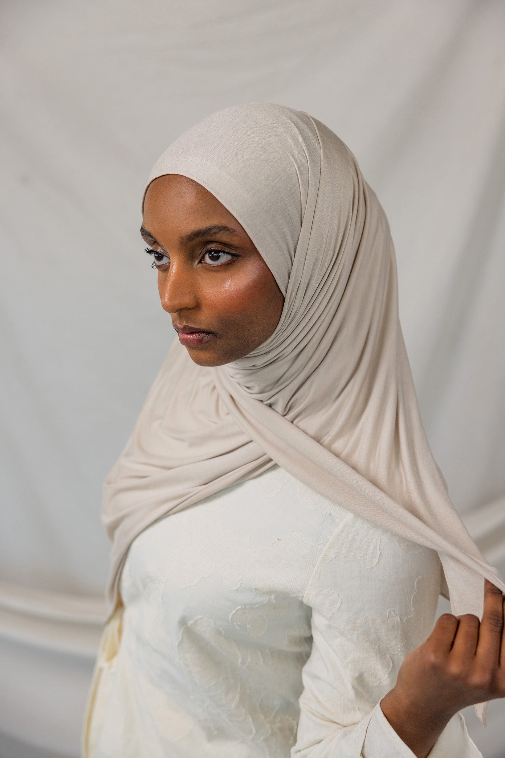 Model wearing Ashwood Jersey Lite in a loose front wrap, showing its versatile neutral hue and stretch.