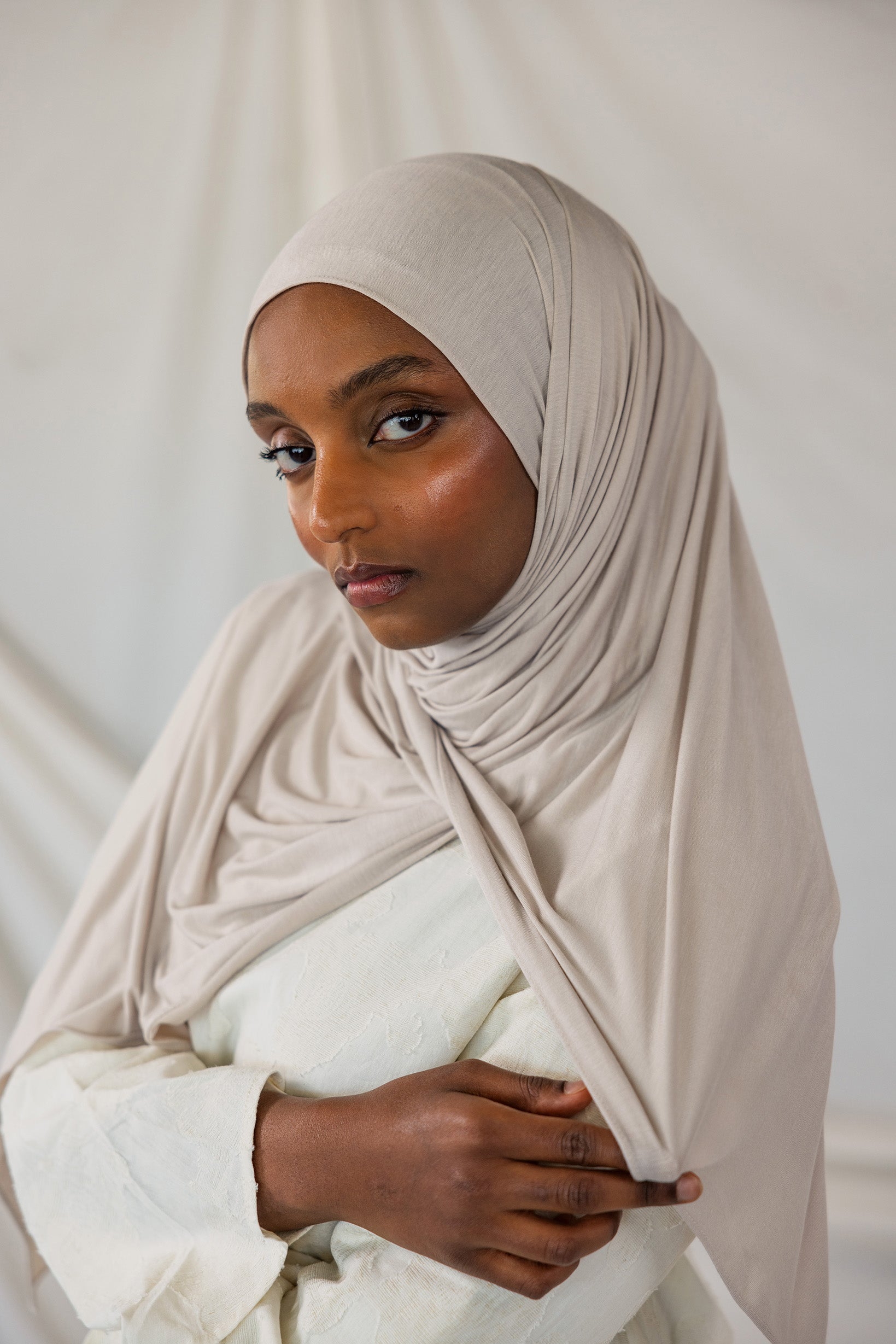 Model wearing Ashwood Jersey Lite in a loose front wrap, showing its versatile neutral hue and wrinkle-resistant drape.
