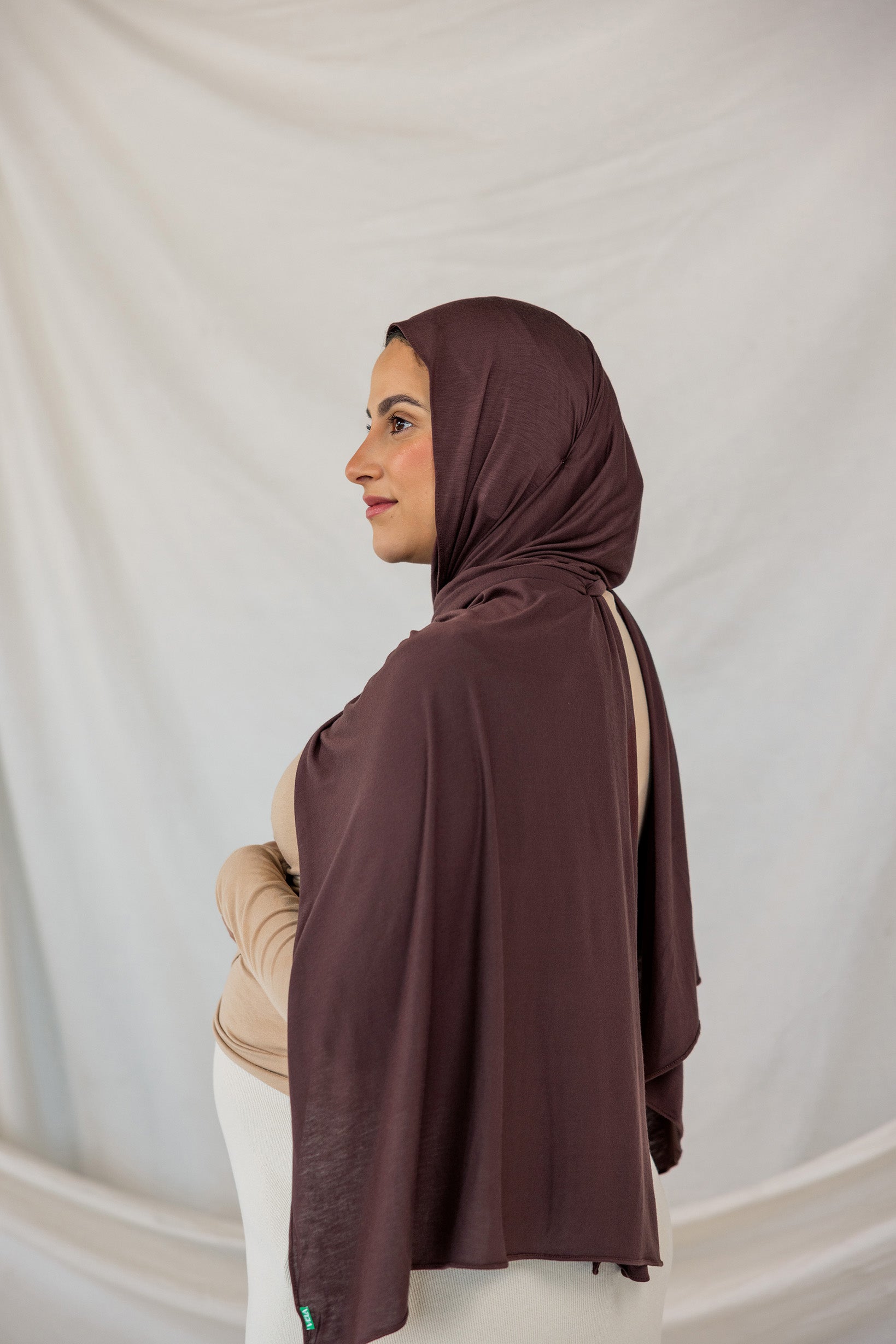 Model wearing Espresso Jersey Lite in a polished style, showcasing wrinkle-resistant and breathable qualities.