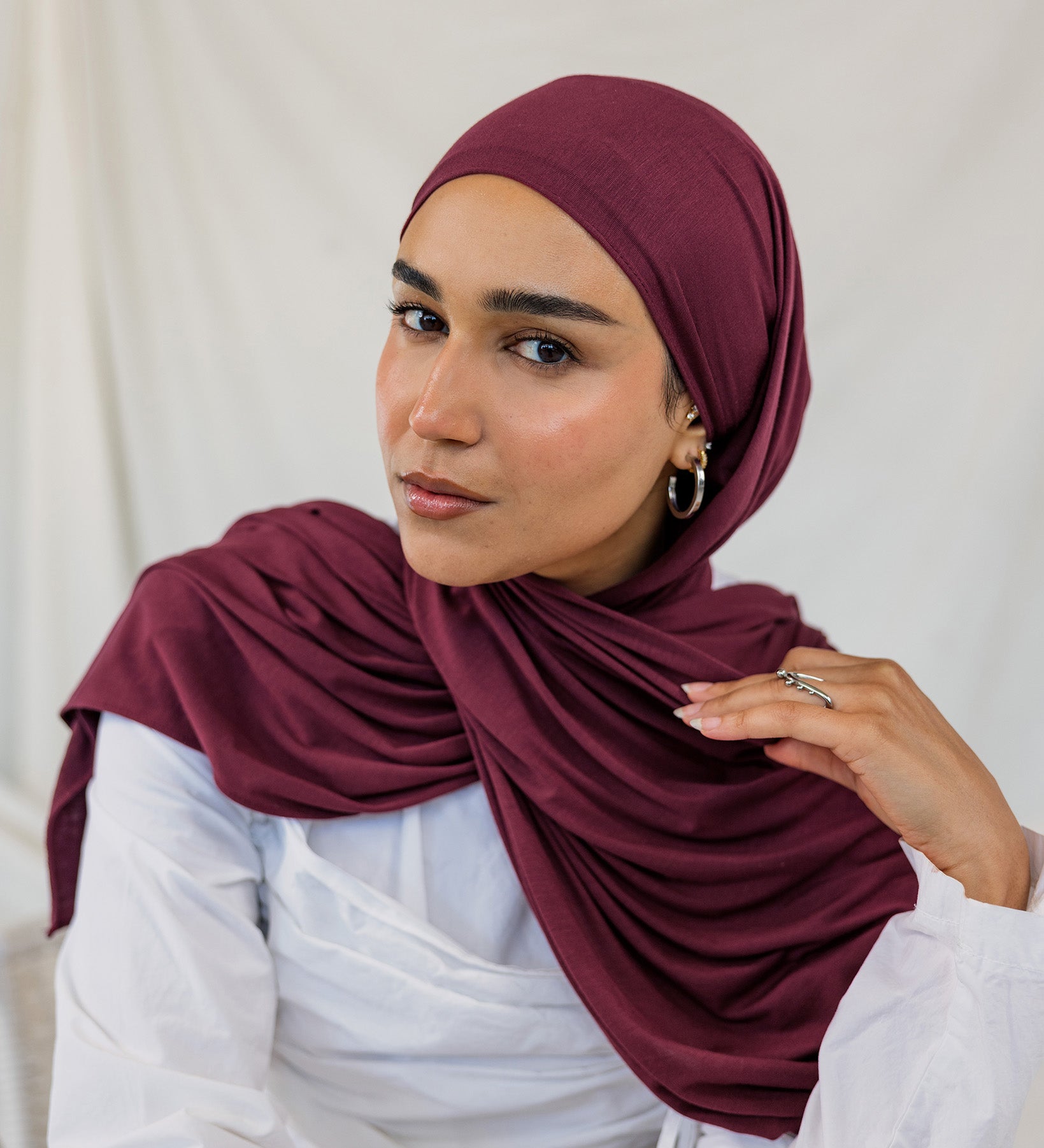 Model wearing Antique Cherry Jersey Lite in a relaxed wrap style, highlighting its deep, berry tone.