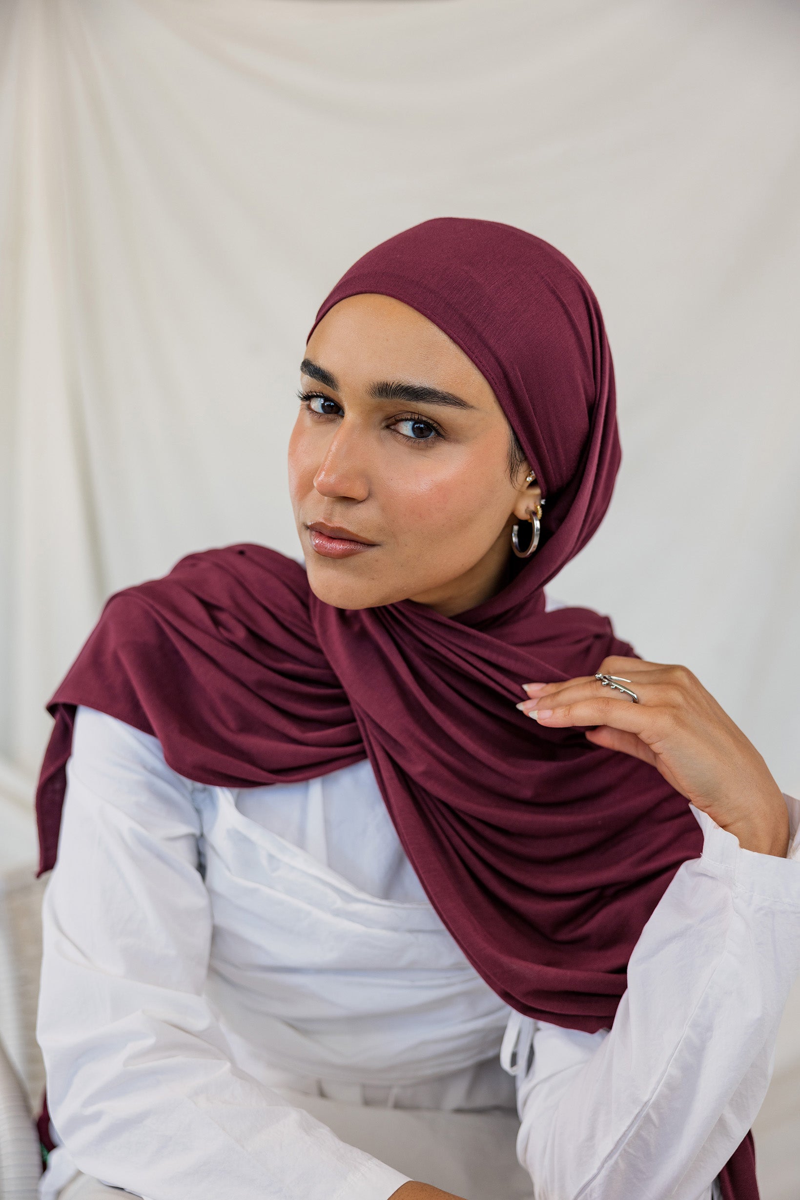 Model wearing Antique Cherry Jersey Lite in a relaxed wrap style, highlighting its deep, berry tone.