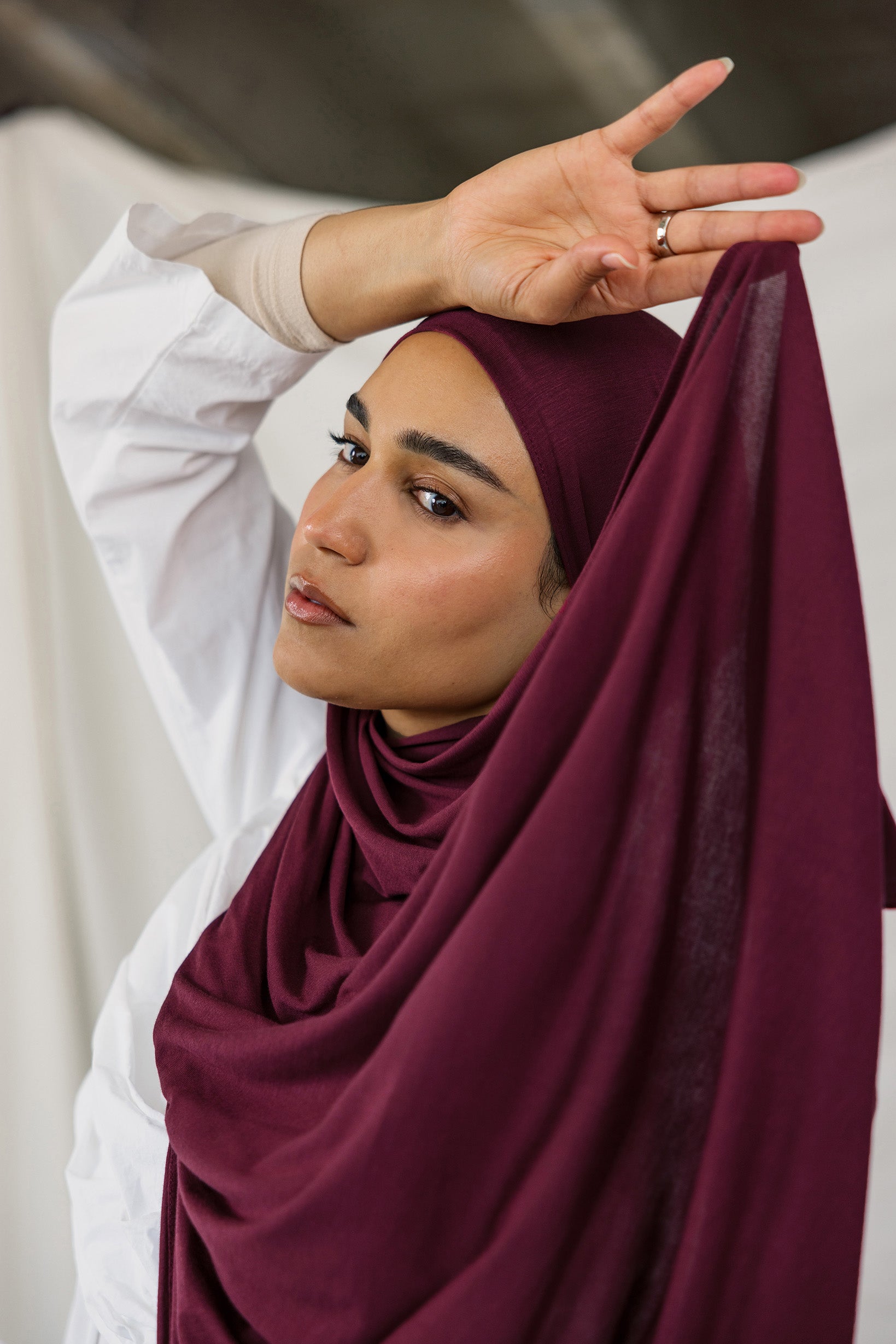 Model wearing Antique Cherry Jersey Lite in a relaxed wrap style, highlighting its deep, bold tone and wrinkle-free look.