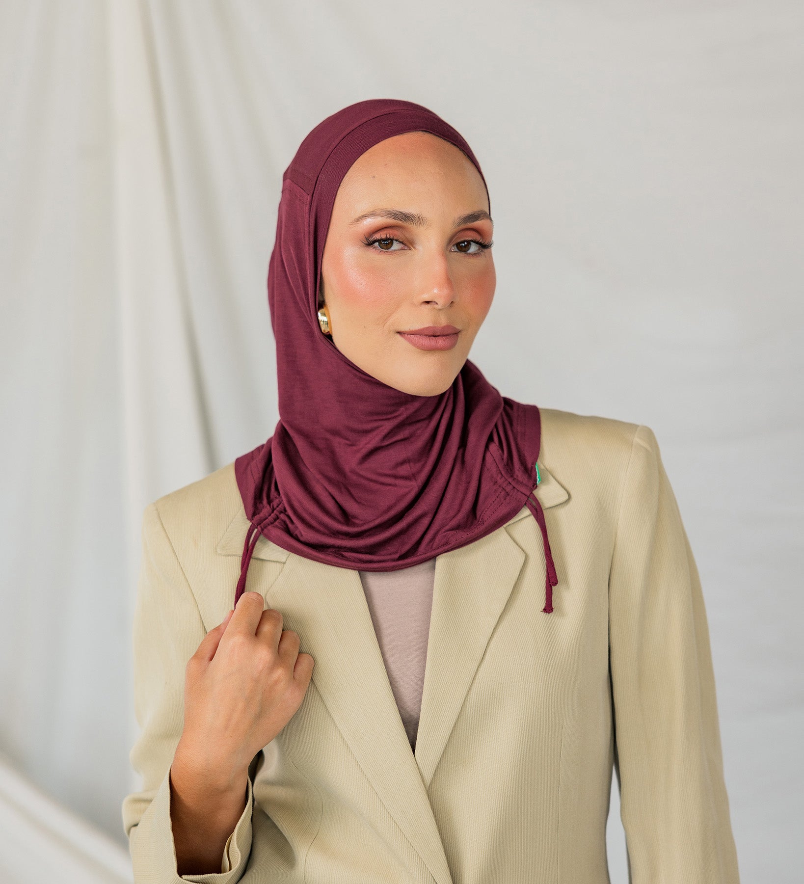 Model wearing Antique Cherry Ruching Lite, emphasizing the deep maroon hue and ruching structure.