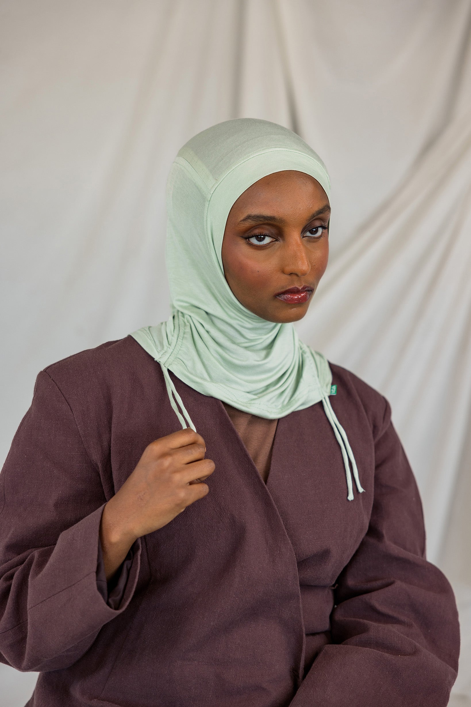 Model shown in front-facing image, wearing the Sage Mist Ruching Lite hijab.