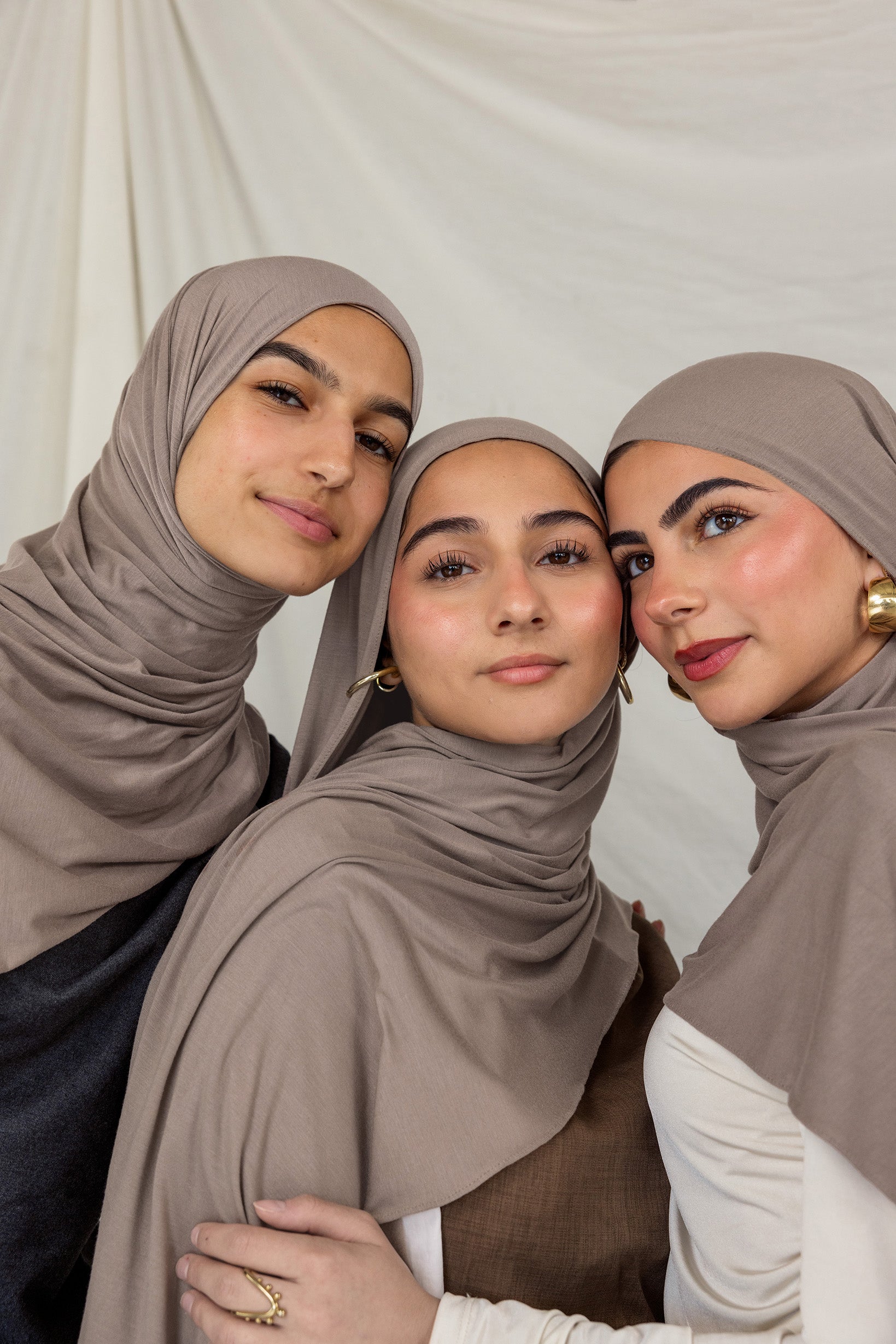 Three models wearing Truffle Mink Jersey Lite highlighting the versatility of the hijab color.