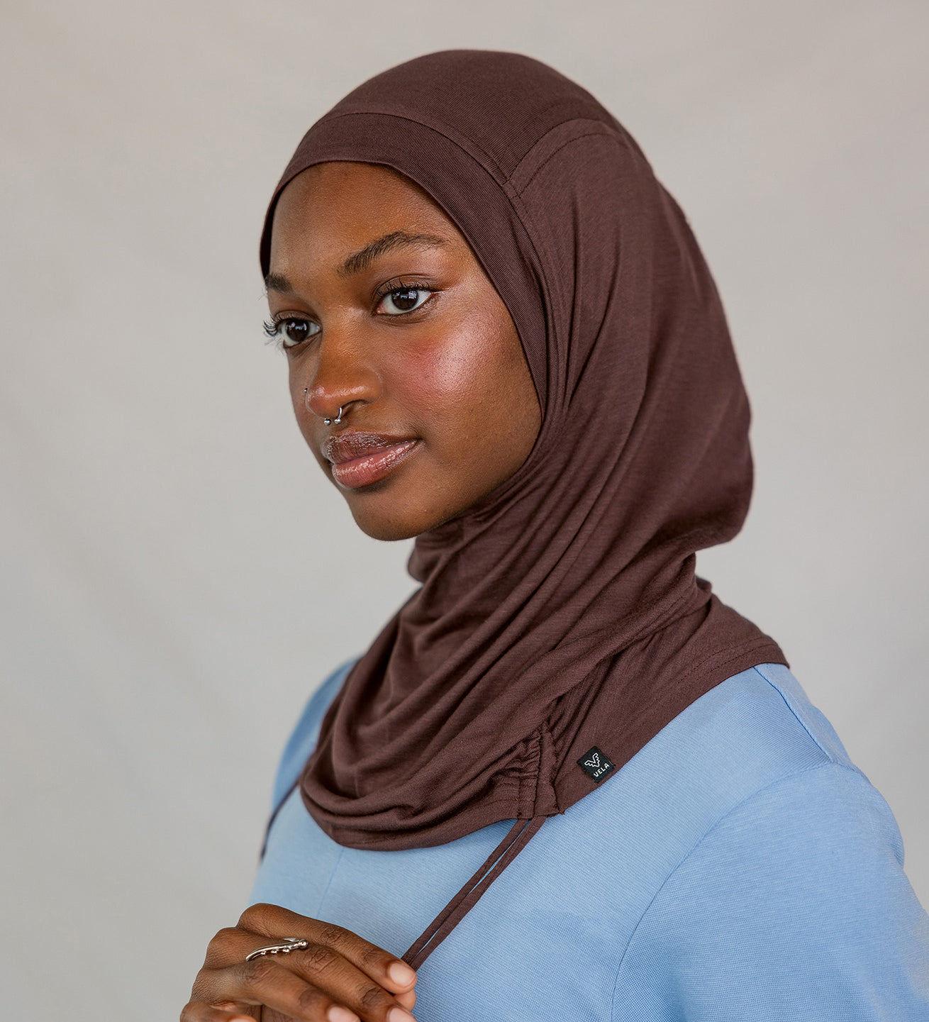 Model wearing Espresso Ruching Lite with ruching along the edge, showing breathable, soft fabric.
