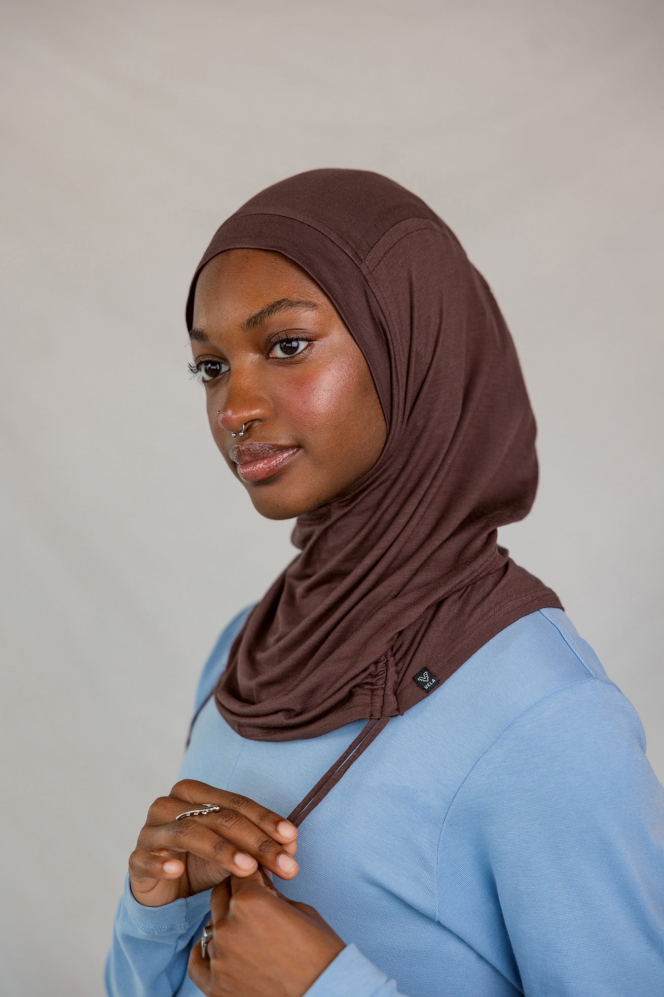 Model wearing Espresso Ruching Lite with ruching along the edge, showing breathable, soft fabric.