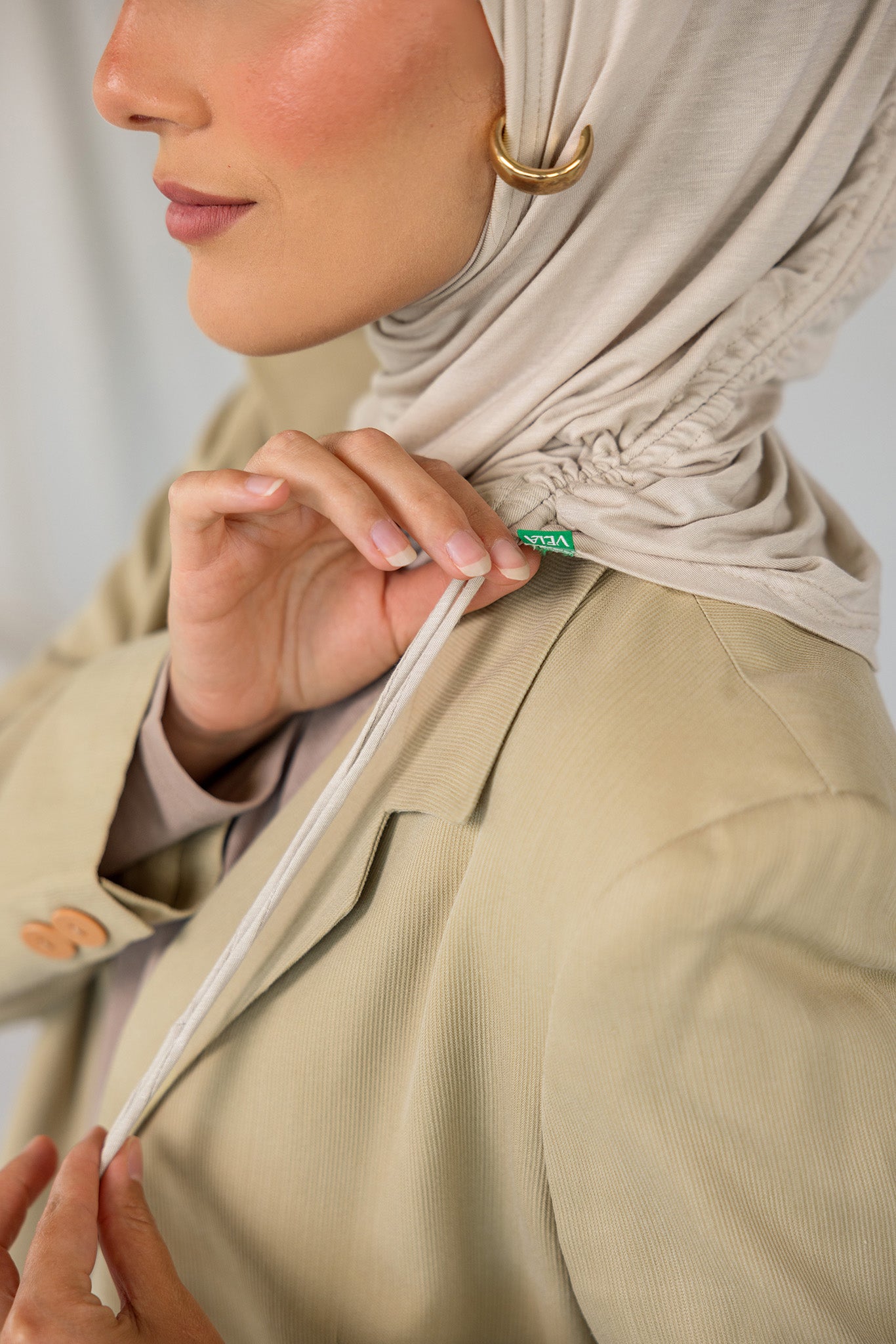 Model wearing Ashwood Ruching Lite, showcasing the neutral tone styled to show ruching detail.