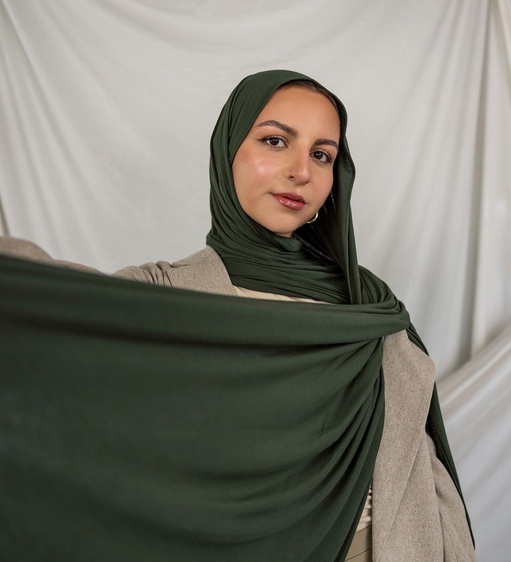 Model wearing Hunter Green Jersey Lite styled in a loose wrap, showcasing its breathable, wrinkle-resistant drape.