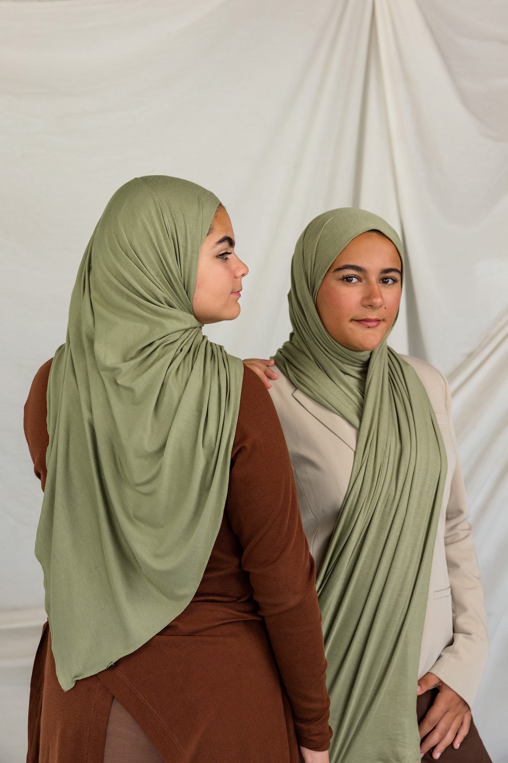 Two models wearing Palm Desert Jersey Lite, showcasing the earthy olive tone in different wrap styles.