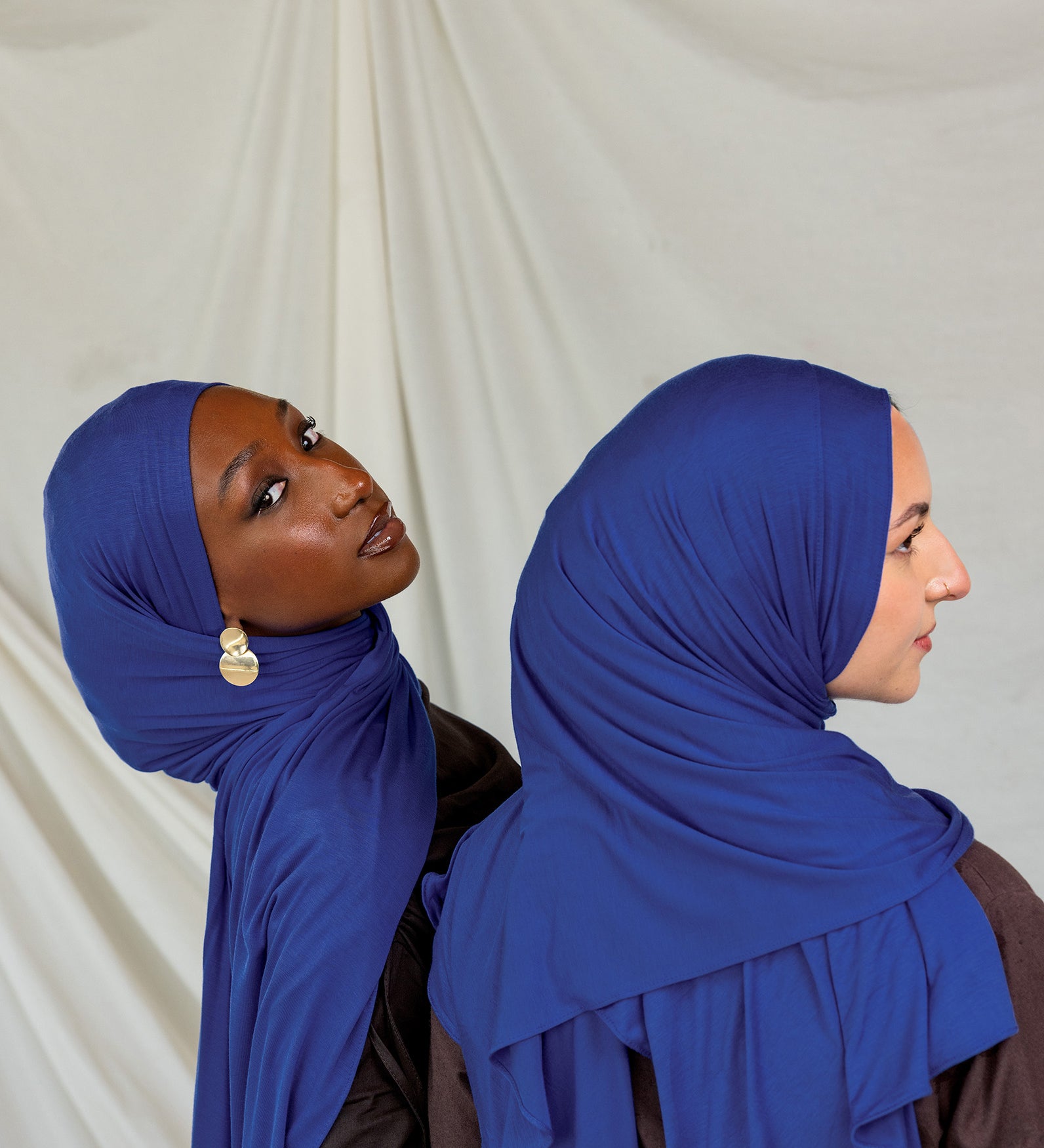 Two models wearing Ocean Blue Jersey Lite, one looking out and one front facing displaying its deep, saturated blue in different angles.