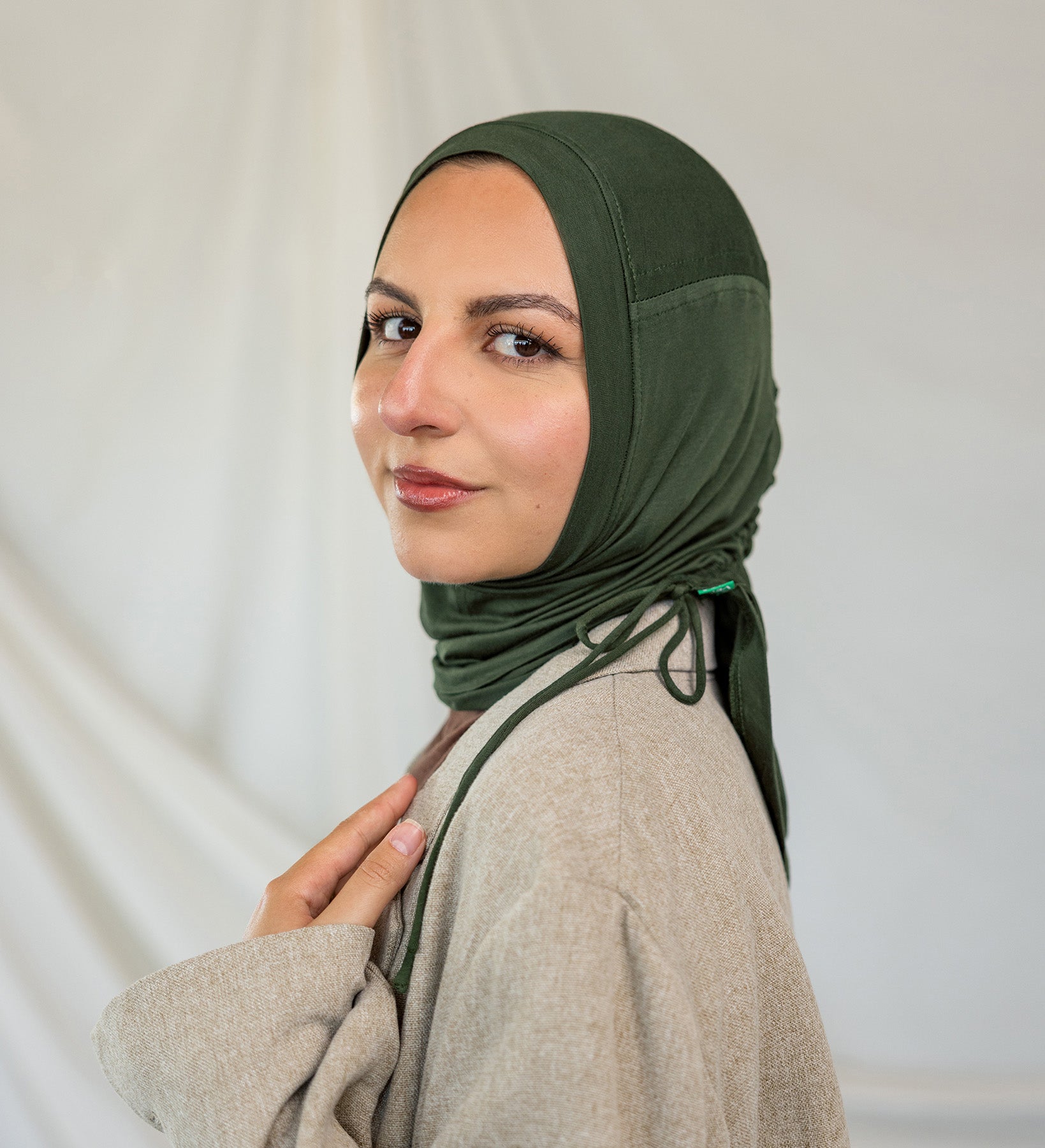 Model wearing Hunter Green Ruching Lite, displaying the ruched detailing and wrinkle-resistant fabric.
