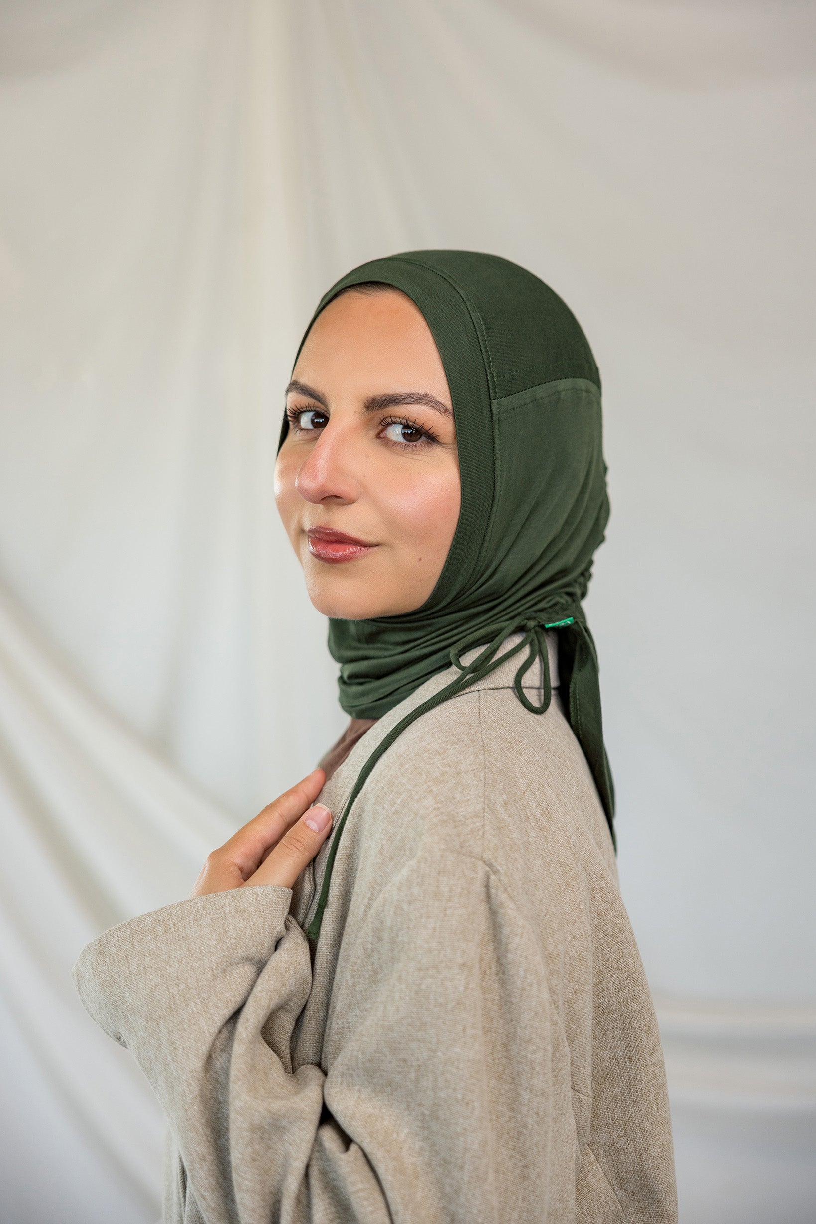 Model wearing Hunter Green Ruching Lite, displaying the ruched detailing and wrinkle-resistant fabric.