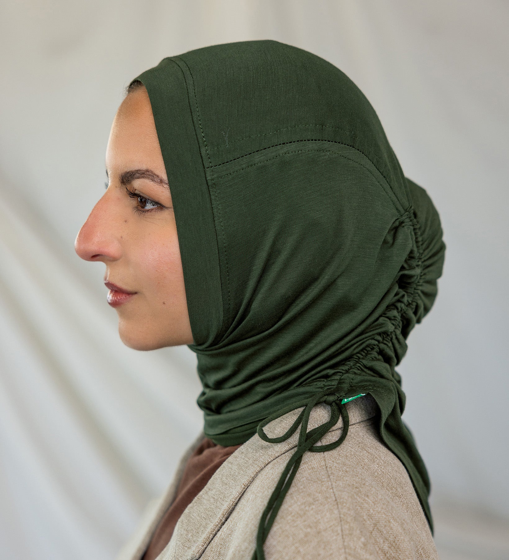 Model wearing Hunter Green Ruching Lite, highlighting ruching effect and deep green shade.