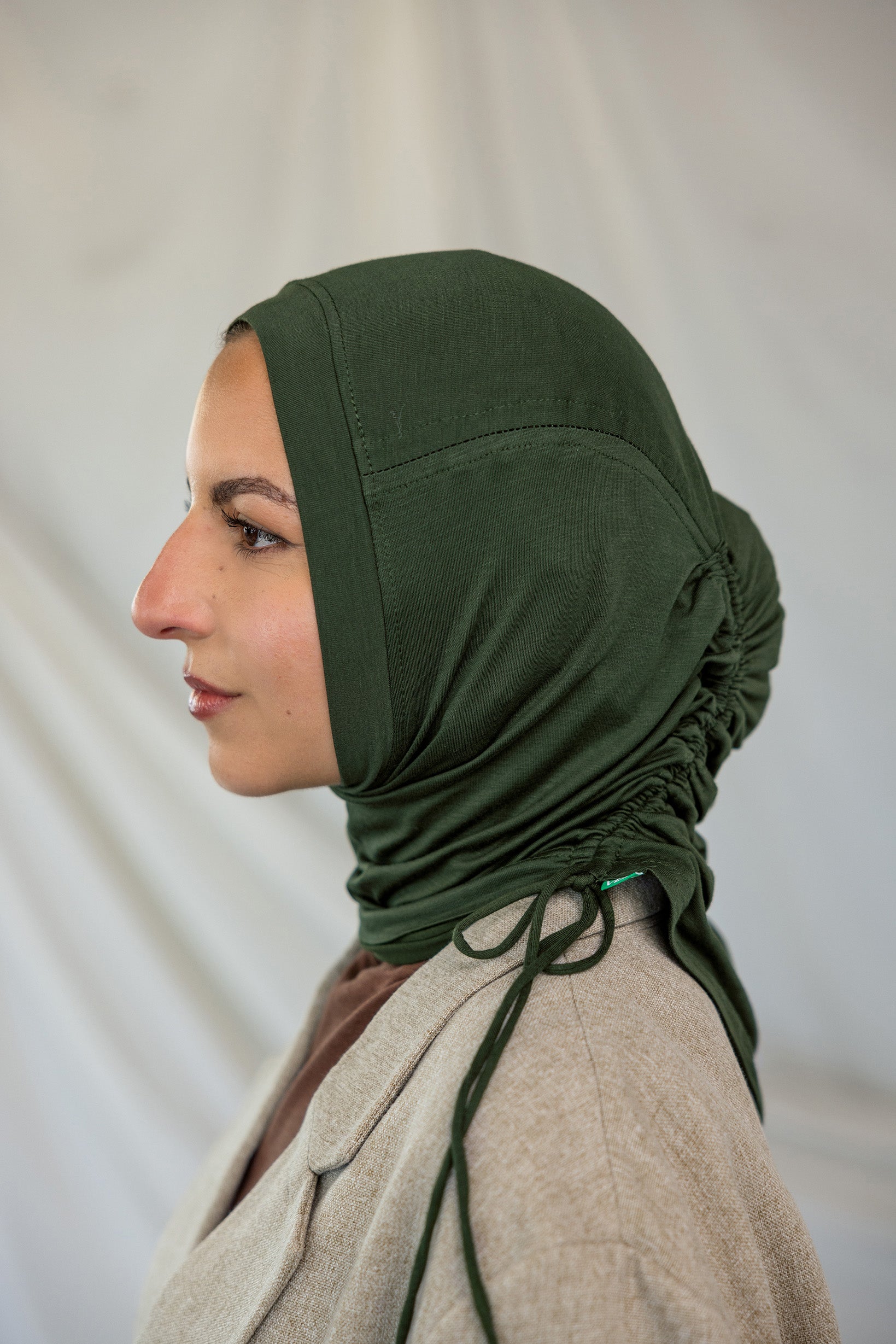 Model wearing Hunter Green Ruching Lite, highlighting ruching effect and deep green shade.
