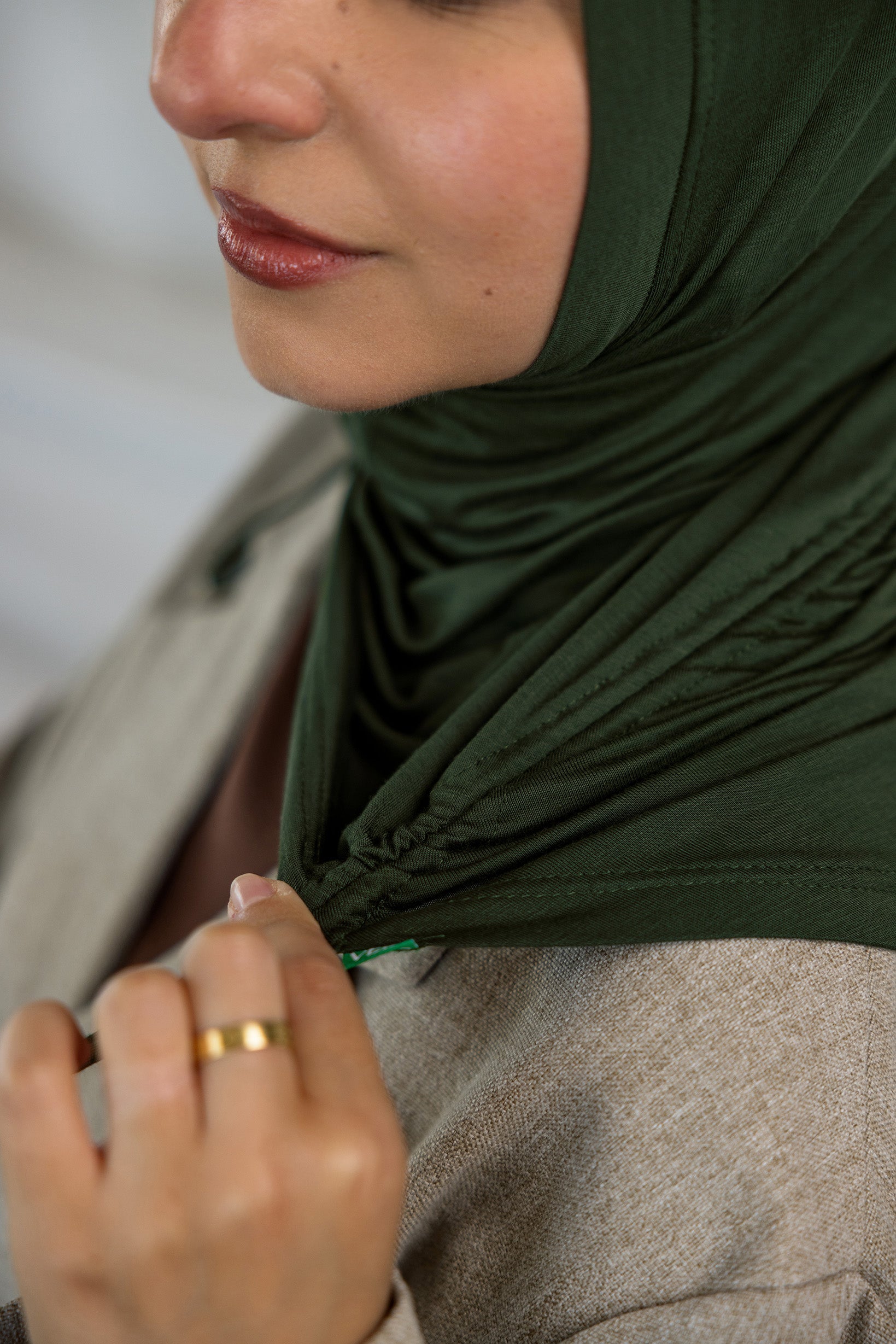 Close-up of model stretching her Hunter Green Ruching Lite.