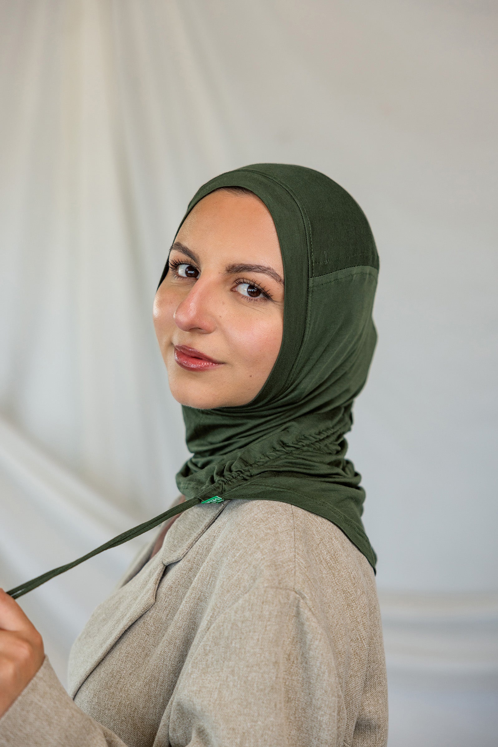 Model wearing Hunter Green Ruching Lite, highlighting the ruching ties.