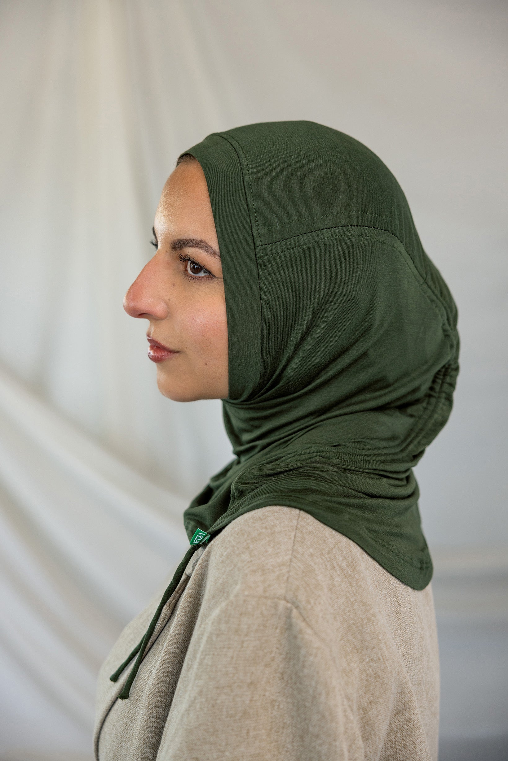 Model wearing Hunter Green Ruching Lite, highlighting ruching effect.