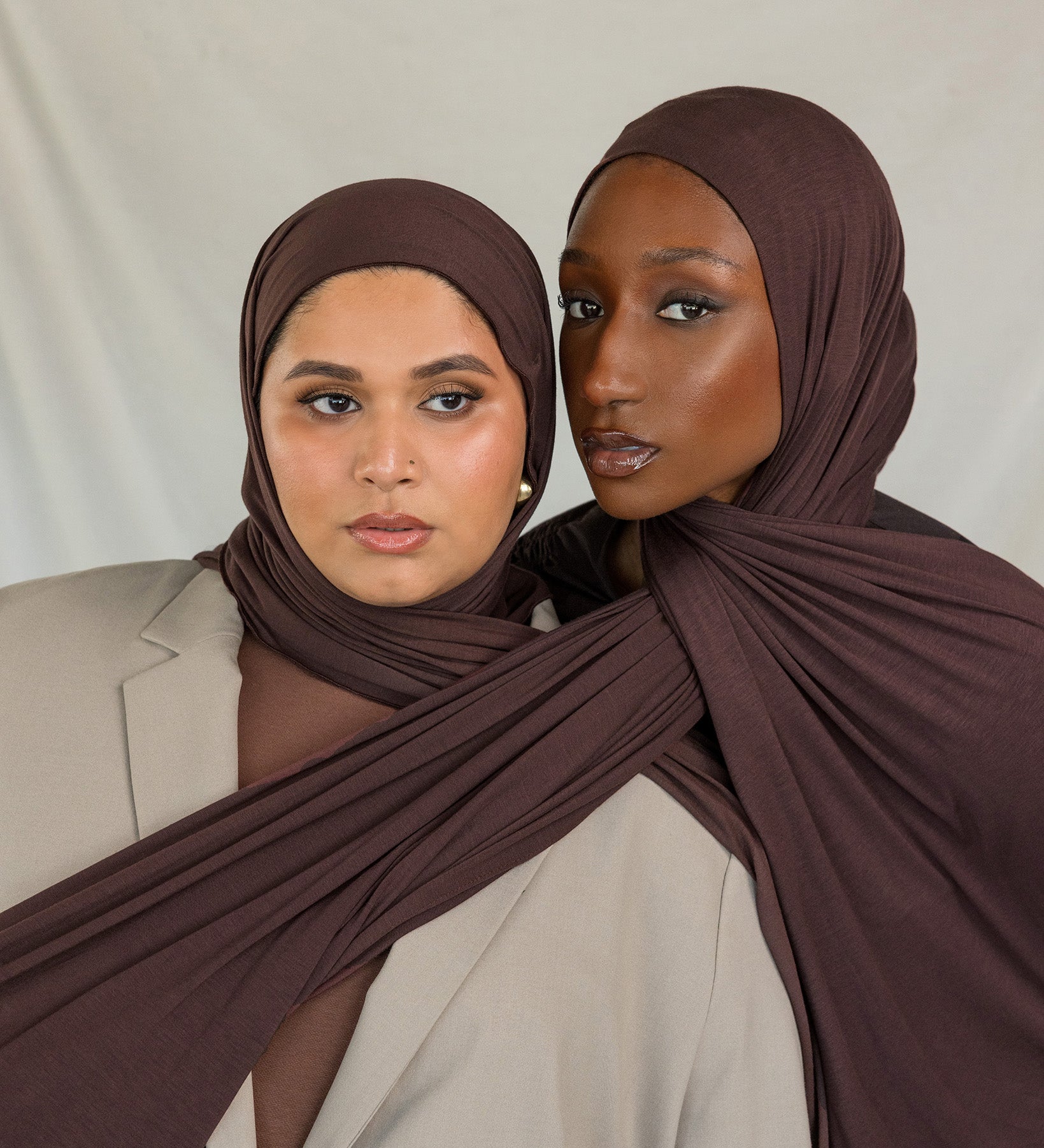 Two models wearing Espresso Jersey Lite, demonstrating its stretch and rich hues.