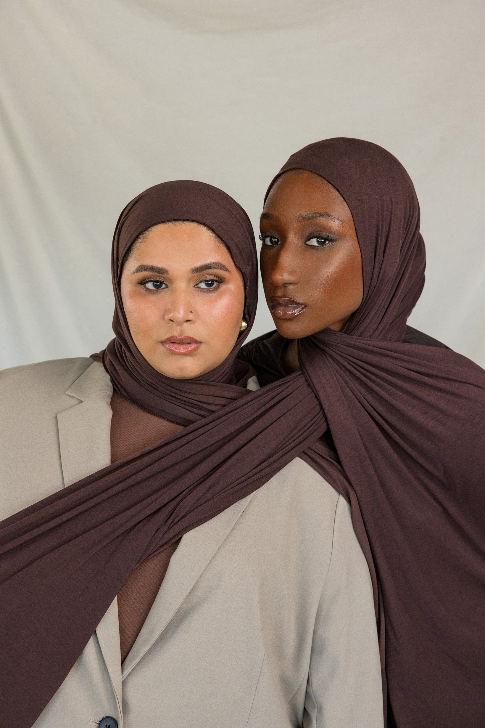 Two models wearing Espresso Jersey Lite, demonstrating its stretch and rich hues.