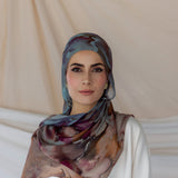 Model wearing handmade hijab with watercolor-style florals and a serene, airy texture.