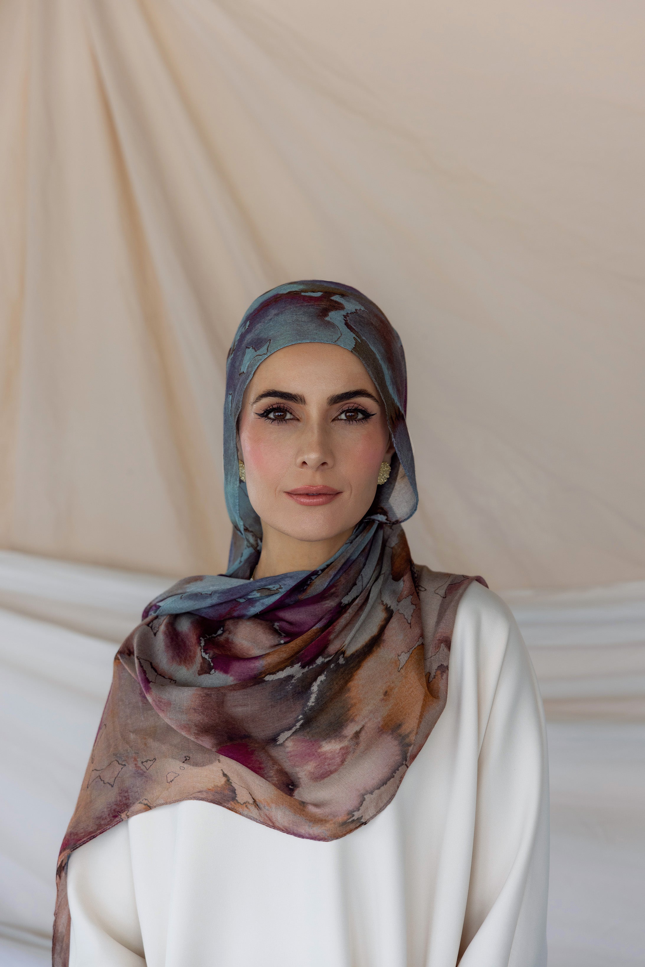 Model wearing handmade hijab with watercolor-style florals and a serene, airy texture.