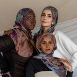 Three Models wearing modal hijab with a floral watercolor print that flows softly across the fabric.