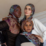Three Models wearing modal hijab with a floral watercolor print that flows softly across the fabric.