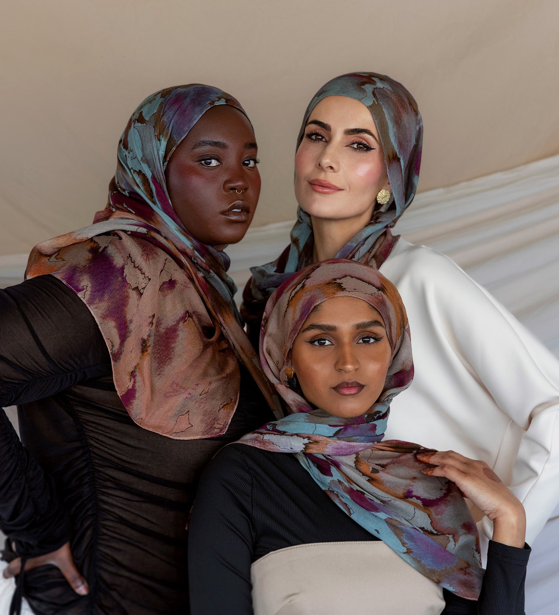 Three Models wearing modal hijab with a floral watercolor print that flows softly across the fabric.