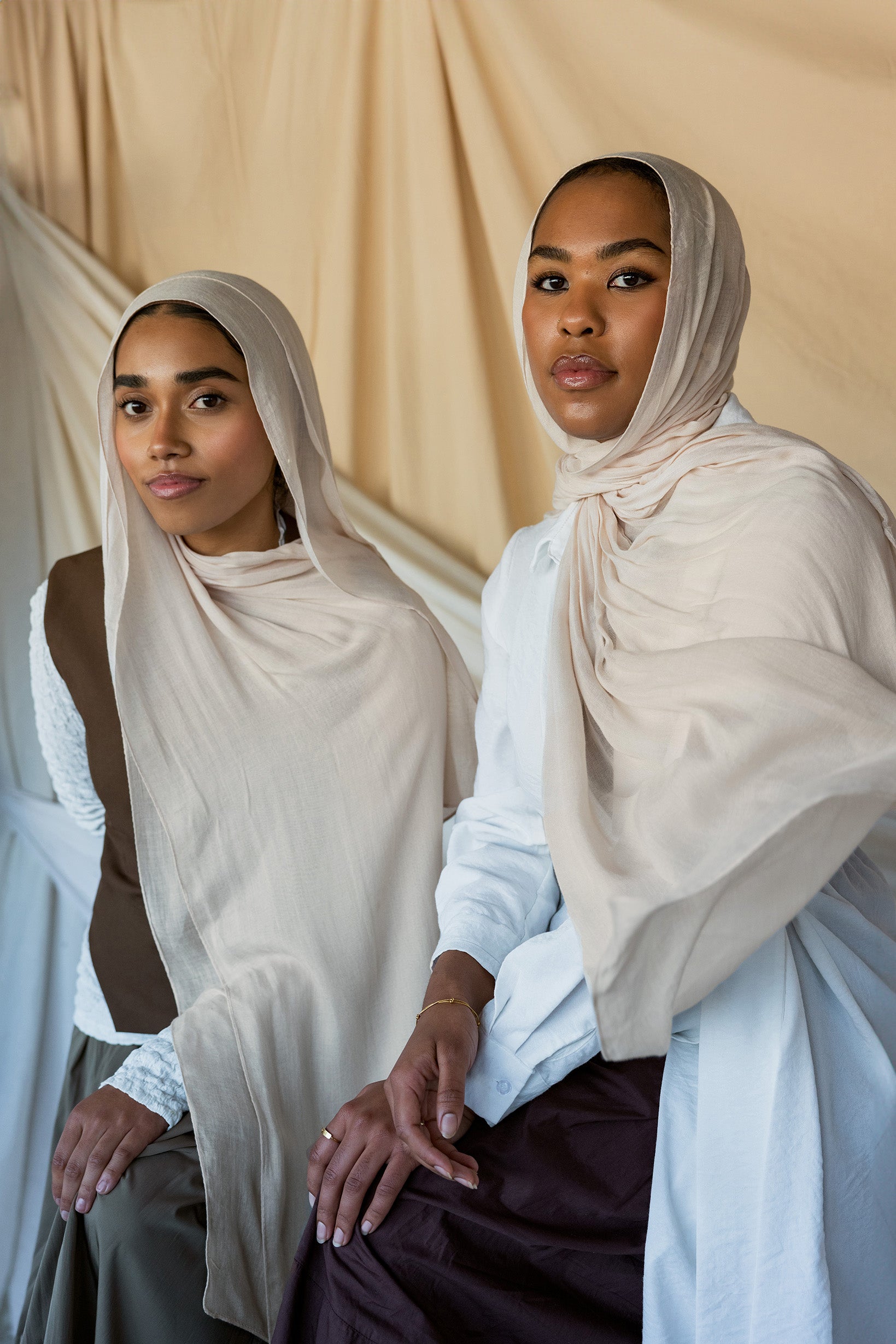 Two Models wearing soft woven hijab with a balanced hue and refined, airy drape