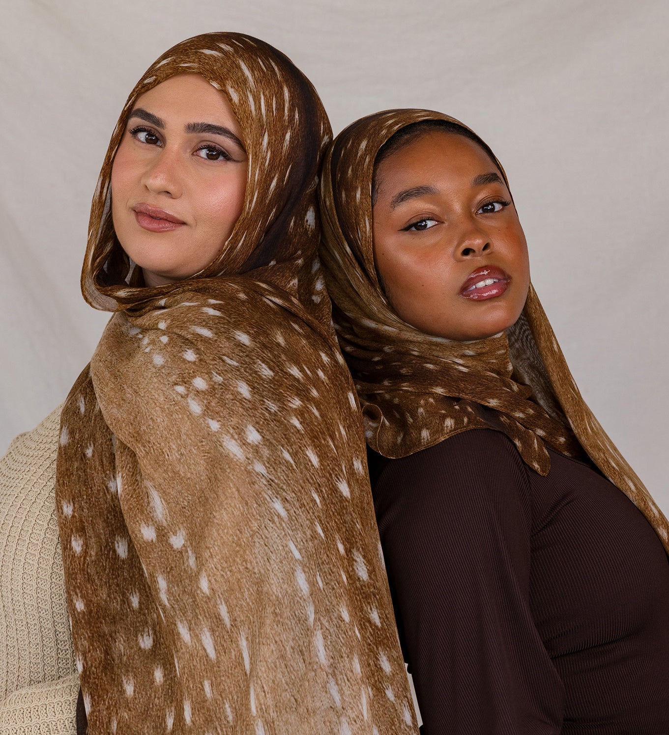 Two models shown, both wearing Fawn from VELA, a warm brown transitional print with white speckles.