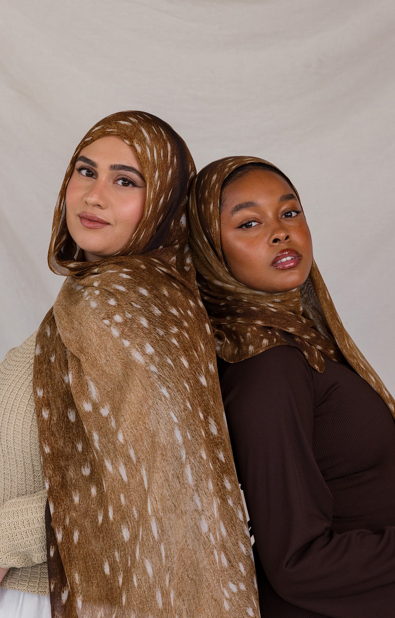Two models shown, both wearing Fawn from VELA, a warm brown transitional print with white speckles.