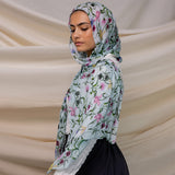 VELA baby blue hijab with small floral print, soft and light for everyday wear.