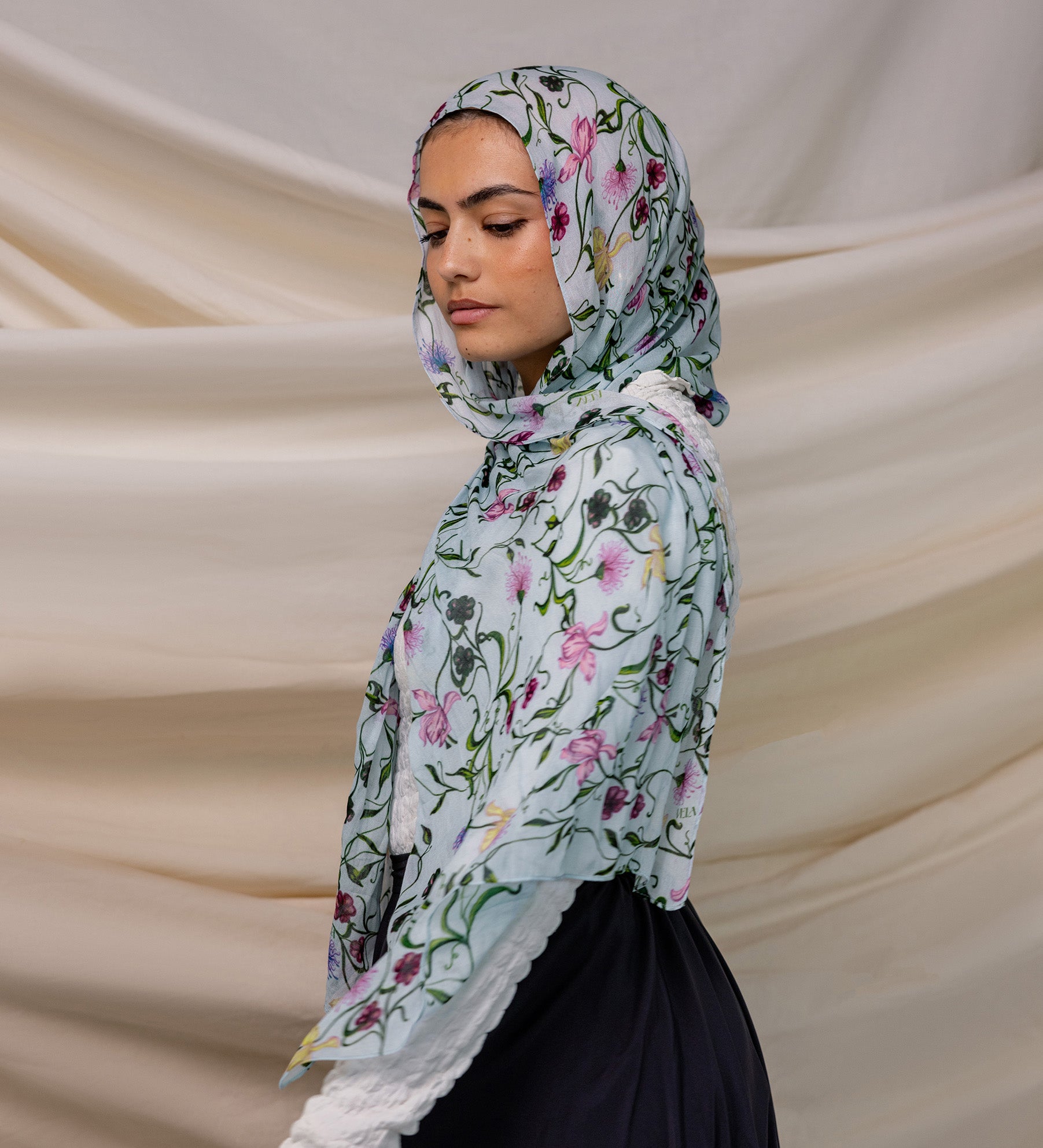 VELA baby blue hijab with small floral print, soft and light for everyday wear.
