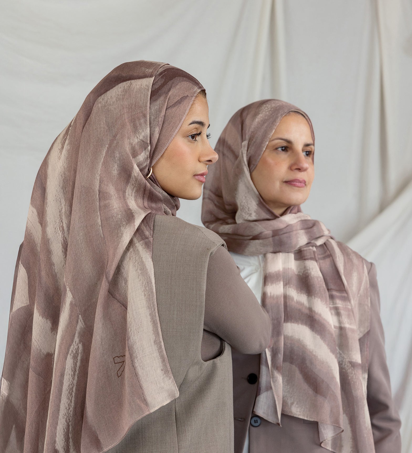 Two models wearing brown sediment printed hijabs