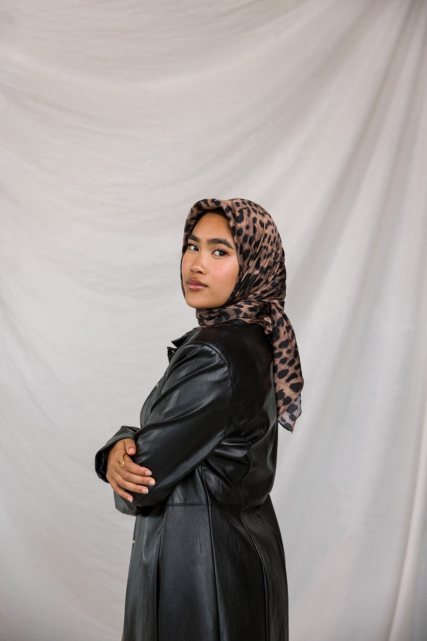 Model styled in a print silk hijab featuring leopard design.