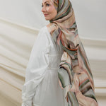 Model wearing full-coverage hijab designed with a flowing, multi-tonal sediment print.