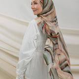 Model wearing full-coverage hijab designed with a flowing, multi-tonal sediment print.