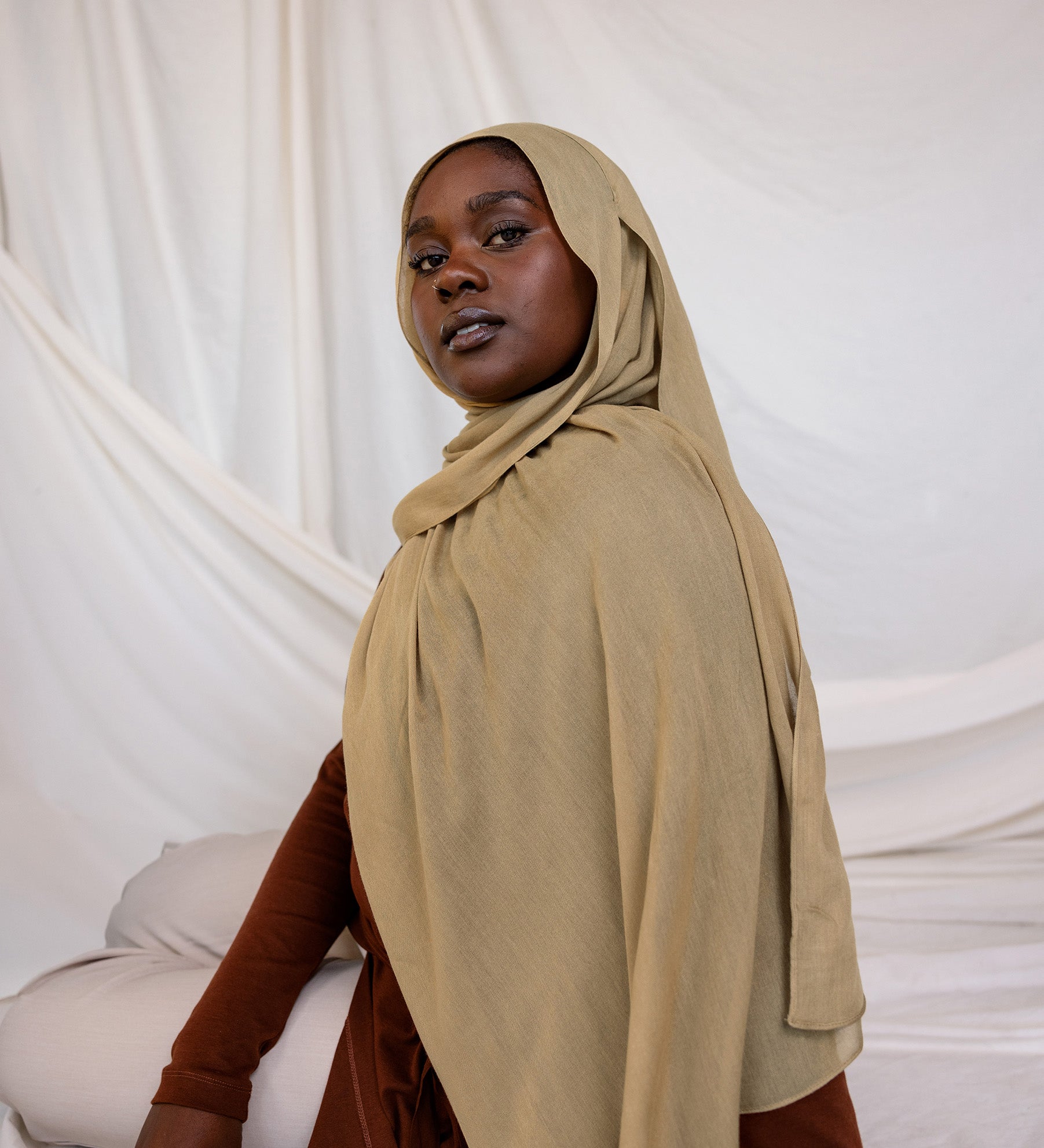 Model shown wearing Sandalwood, an earthy green-brown that has a sand-colored tone. Is a neutral color.
