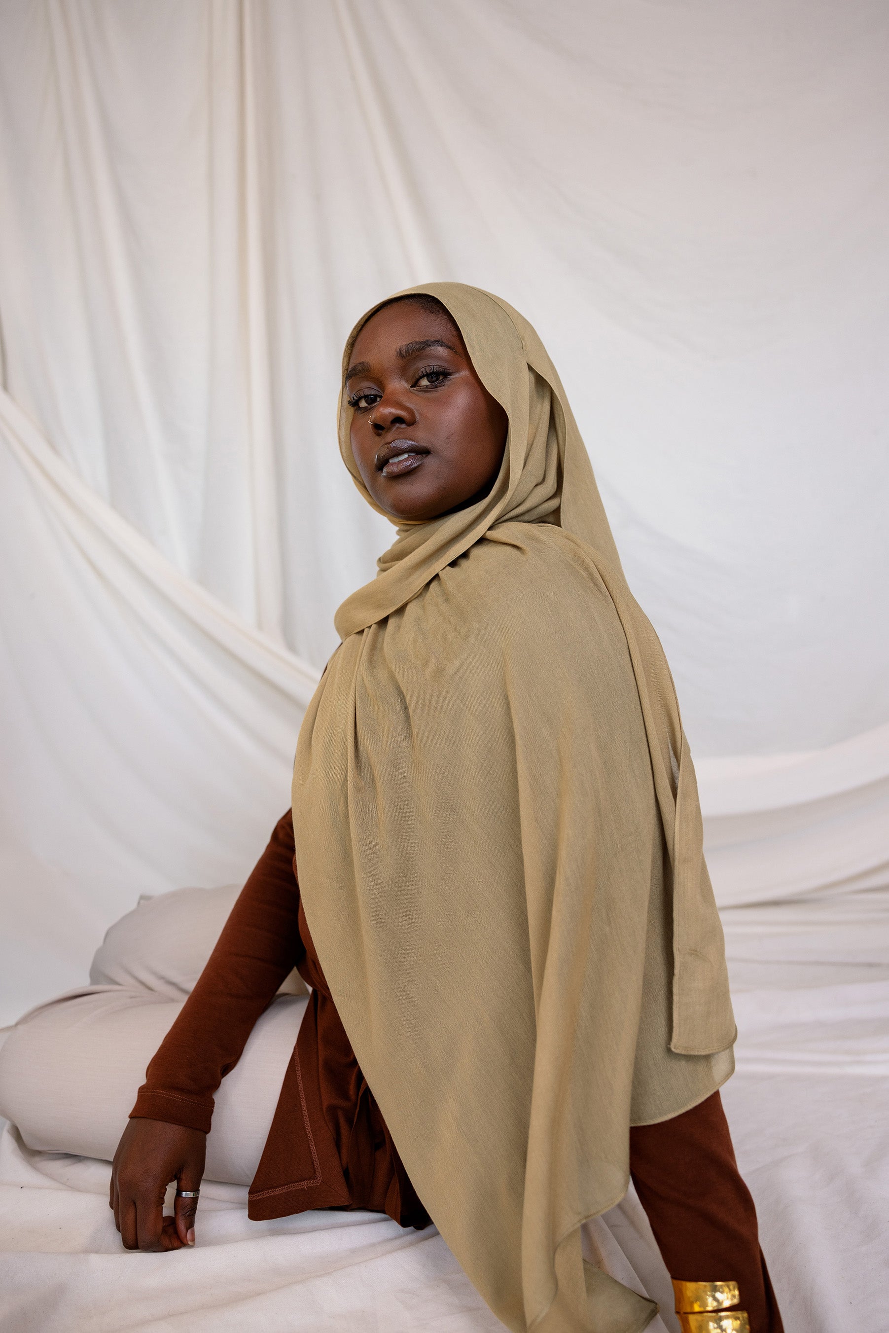 Model shown wearing Sandalwood, an earthy green-brown that has a sand-colored tone. Is a neutral color.