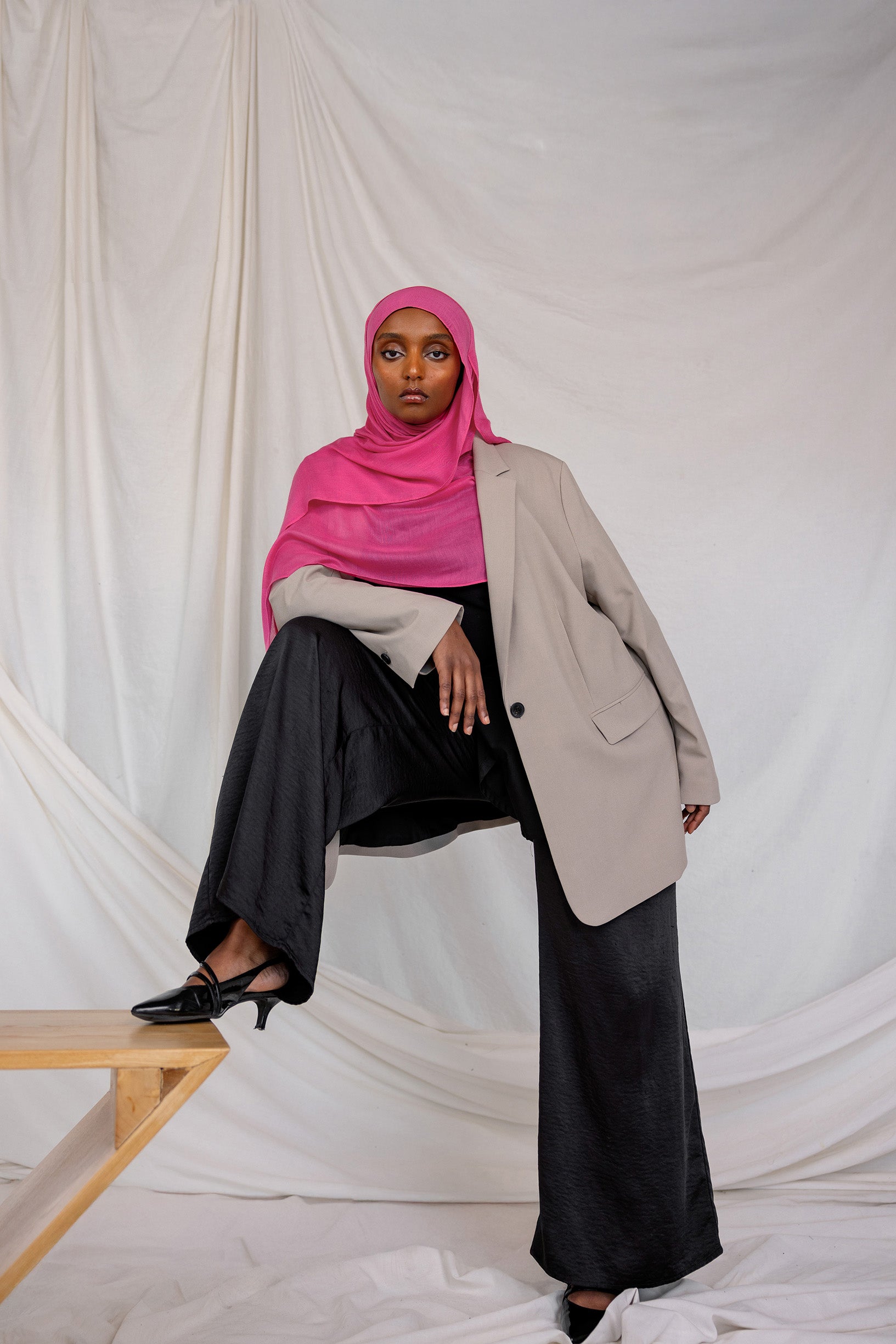 Model shown styled in Rose Wave, a vibrant pink solid scarf.