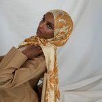 Model wearing modal hijab with tonal botanical print and a soft, natural finish.