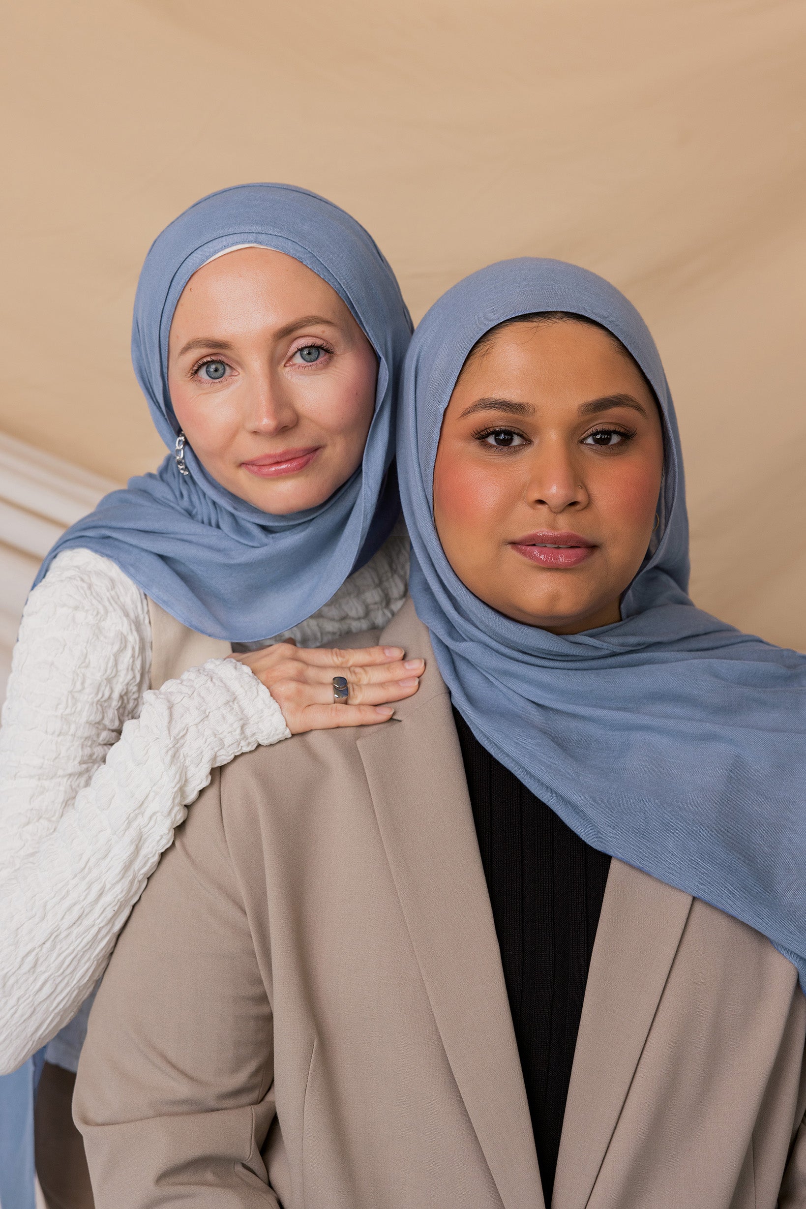 Two models wearing Serenity Blue hijab against a backdrop.