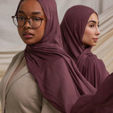 Two models wearing Rosewood hijabs styled against backdrop.