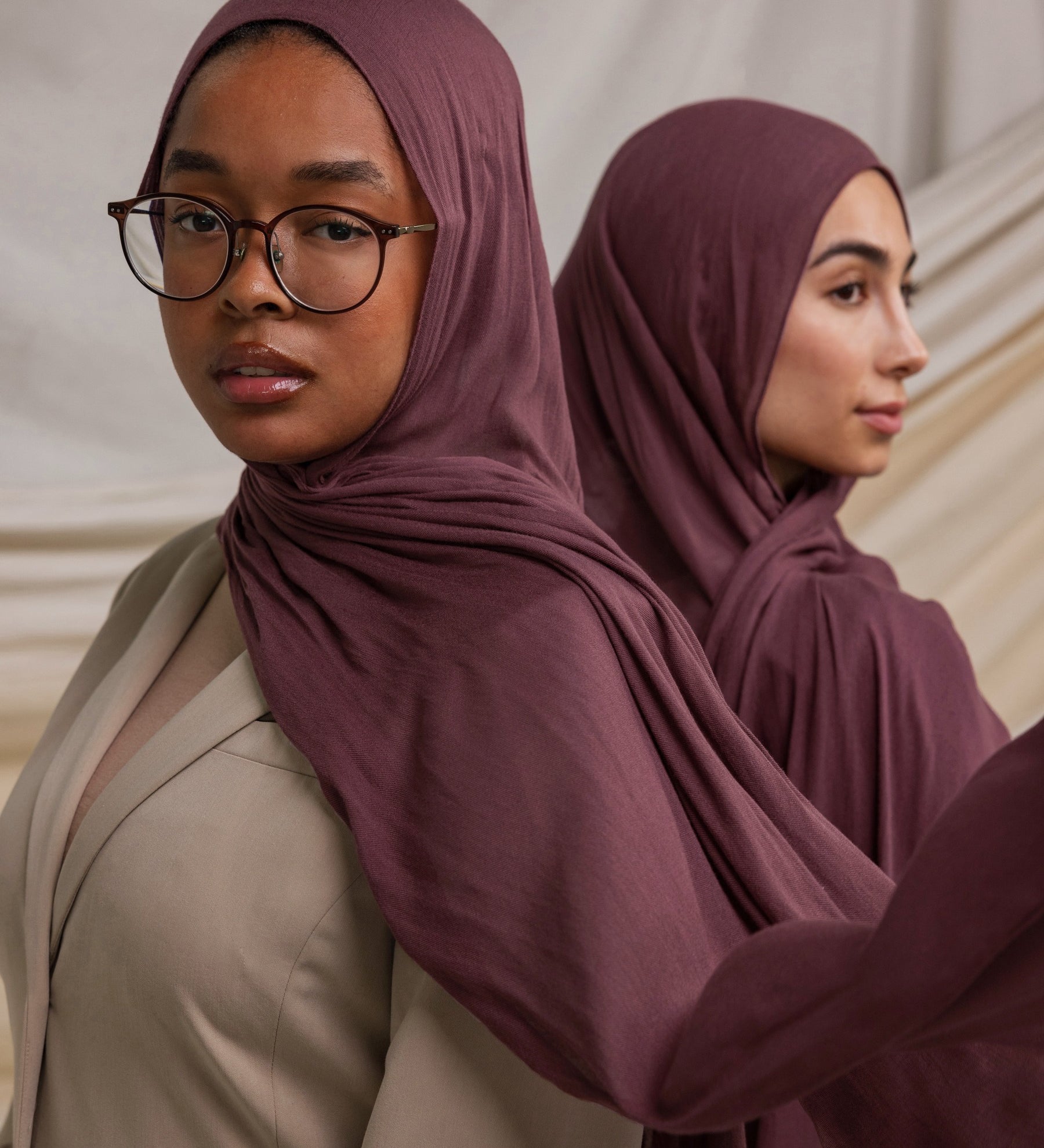 Two models wearing Rosewood hijabs styled against backdrop.