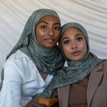 Two girls modeling in a green toned paisley printed hijab.