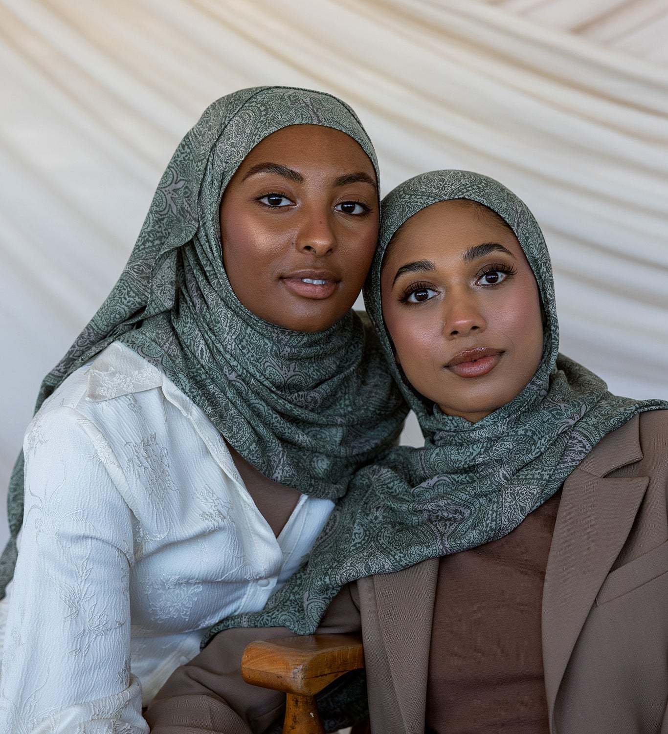 Two girls modeling in a green toned paisley printed hijab.